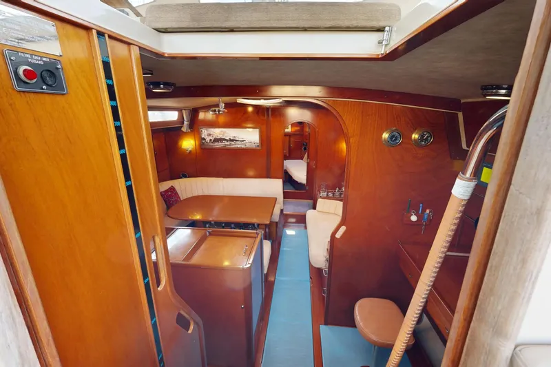  Yacht Photos Pics Interior of 2002 Amel Super Maramu 2000 sailboat, featuring cozy wooden furnishings.