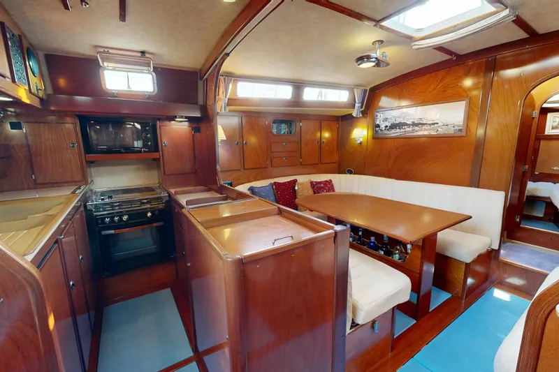  Yacht Photos Pics Luxurious interior of a 2002 Amel Super Maramu 2000 yacht with elegant wood finishes.