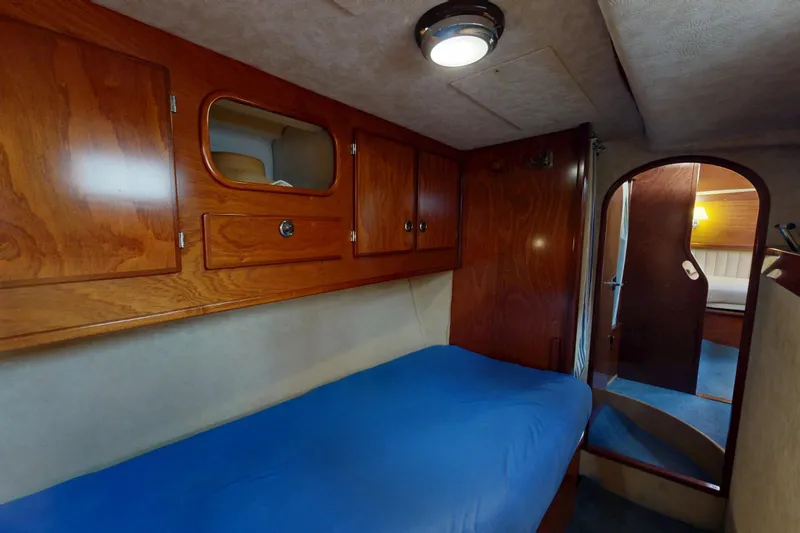  Yacht Photos Pics Cozy cabin interior of 2002 Amel Super Maramu 2000 yacht with wooden cabinetry.