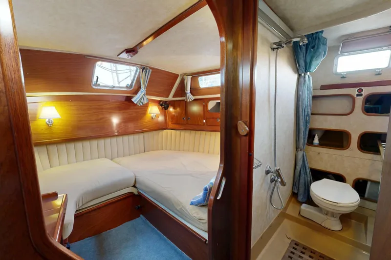  Yacht Photos Pics Luxurious cabin interior of 2002 Amel Super Maramu 2000 yacht with bed and bathroom.