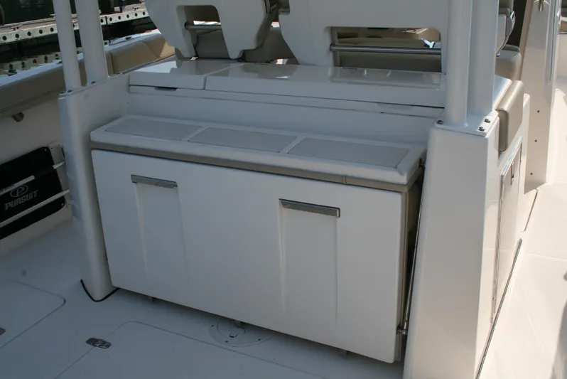  Yacht Photos Pics 2018 Pursuit S 328 Sport boat interior with storage compartment.