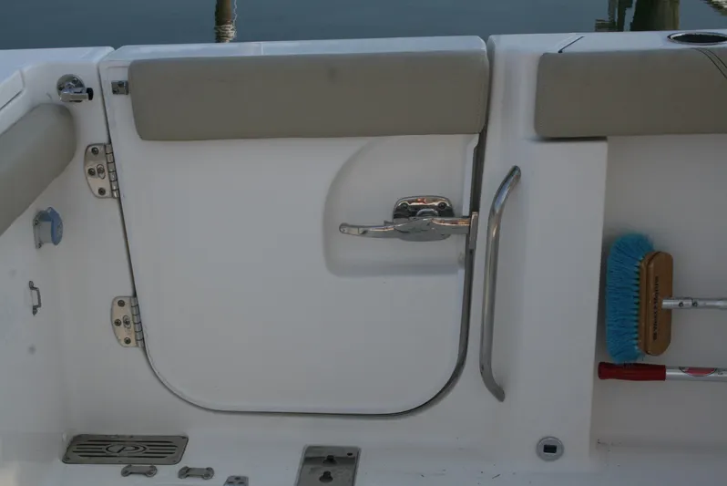  Yacht Photos Pics 2018 Pursuit S 328 Sport boat interior with door and cleaning brush.