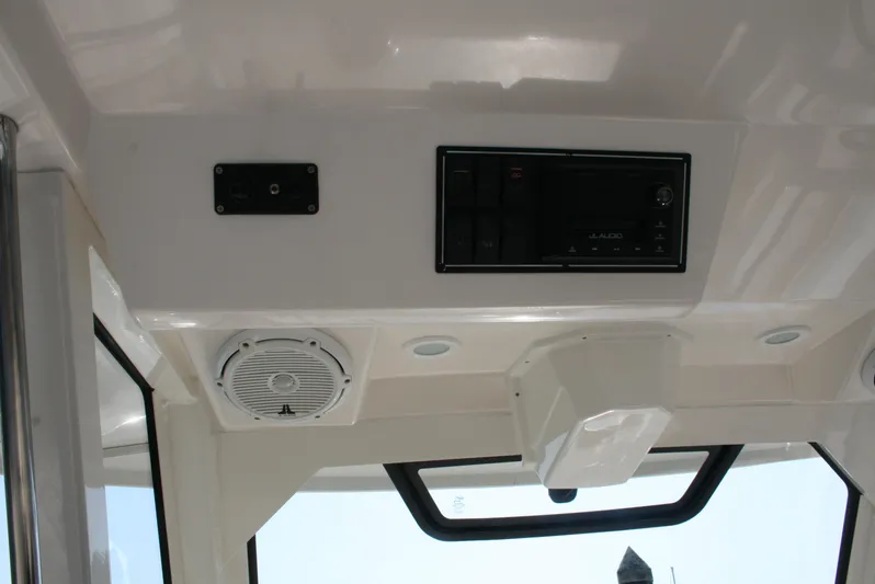  Yacht Photos Pics Interior view of 2018 Pursuit S 328 Sport boat, featuring control panel and speaker.