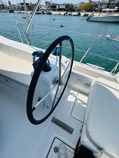 Happy Hour Yacht Photos Pics Steering wheel of a 2020 Beneteau Oceanis 41.1 sailboat docked by the water.