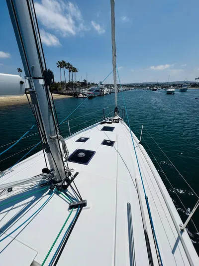 Happy Hour Yacht Photos Pics 2020 Beneteau Oceanis 41.1 sailboat on calm water near a marina.