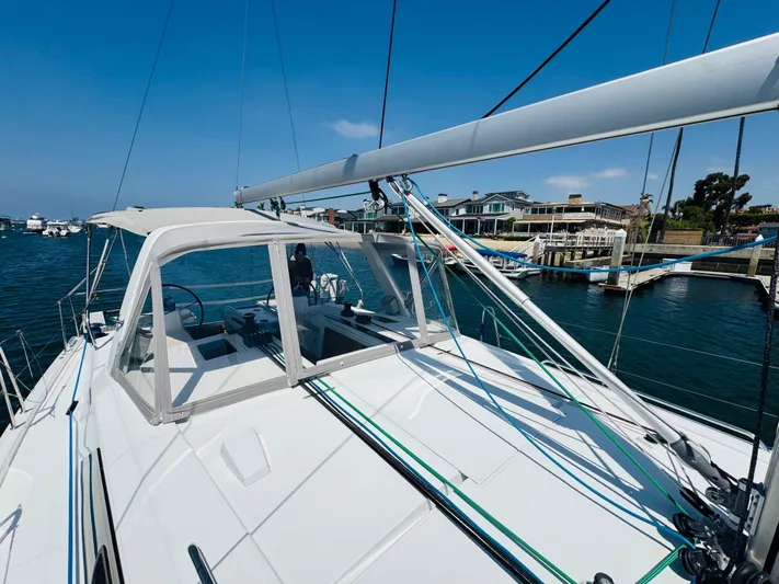 Happy Hour Yacht Photos Pics Sailing yacht Beneteau Oceanis 41.1, 2020 model, docked in a marina under clear blue skies.