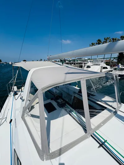 Happy Hour Yacht Photos Pics 2020 Beneteau Oceanis 41.1 sailboat with canopy, docked in a sunny marina.