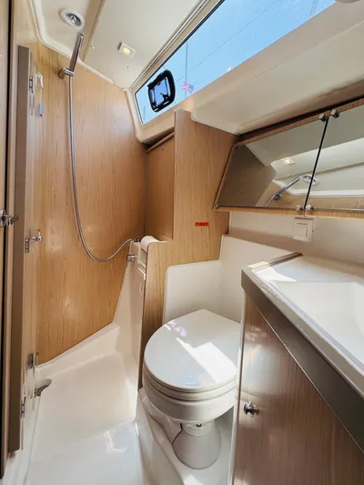 Happy Hour Yacht Photos Pics 2020 Beneteau Oceanis 41.1 yacht bathroom with modern fixtures and wood accents.