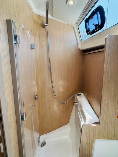 Happy Hour Yacht Photos Pics 2020 Beneteau Oceanis 41.1 yacht shower with wood paneling and modern fixtures.