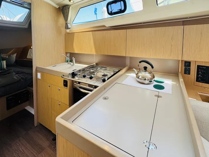 Happy Hour Yacht Photos Pics Interior of 2020 Beneteau Oceanis 41.1 yacht kitchen with stove and kettle.