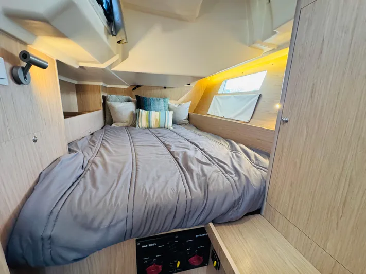 Happy Hour Yacht Photos Pics Cozy cabin interior of 2020 Beneteau Oceanis 41.1 with modern bedding and ambient lighting.