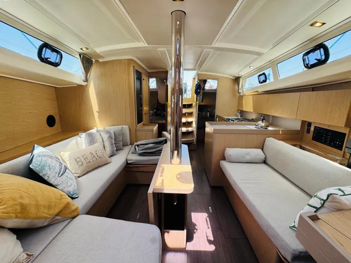 Happy Hour Yacht Photos Pics Luxurious interior of 2020 Beneteau Oceanis 41.1 yacht with modern furnishings and ample natural light.