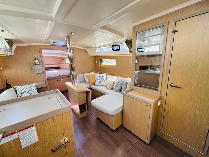 Happy Hour Yacht Photos Pics Modern interior of 2020 Beneteau Oceanis 41.1 yacht with cozy seating and wood finish.