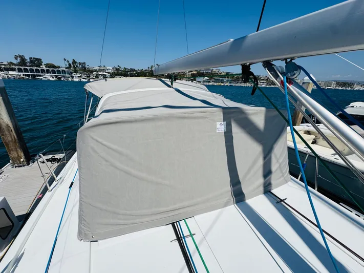 Happy Hour Yacht Photos Pics 2020 Beneteau Oceanis 41.1 sailboat with covered deck, docked in a marina.