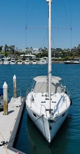 Happy Hour Yacht Photos Pics 2020 Beneteau Oceanis 41.1 sailboat docked in a marina under clear blue skies.