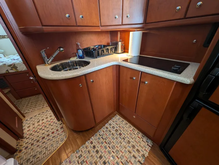  Yacht Photos Pics 2005 Silverton 34 Convertible yacht kitchen with wood cabinets and modern appliances.