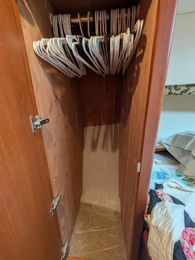  Yacht Photos Pics Wooden closet with hangers in 2005 Silverton 34 Convertible boat interior.