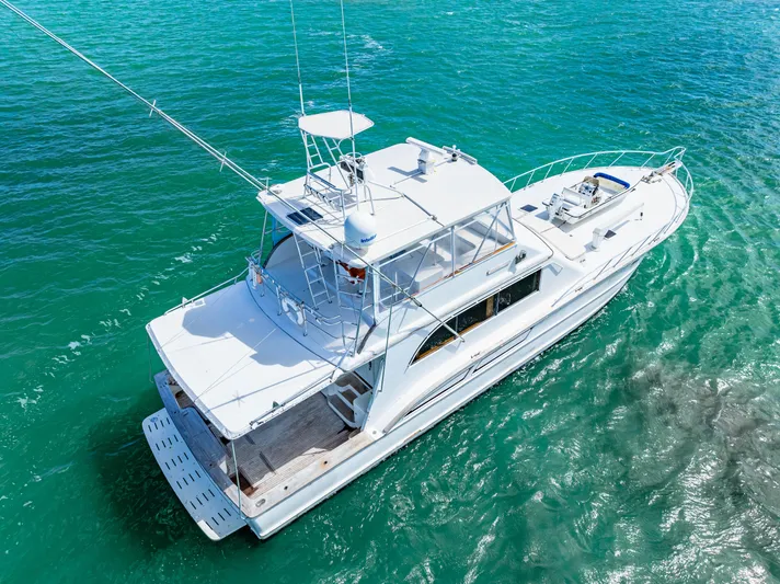 Bahama Belle Yacht Photos Pics Aerial view of a 1996 Blackwell 72 yacht cruising on clear blue waters.