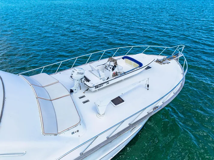 Bahama Belle Yacht Photos Pics Blackwell 72 yacht (1996) with a small boat on deck, sailing in clear blue waters.