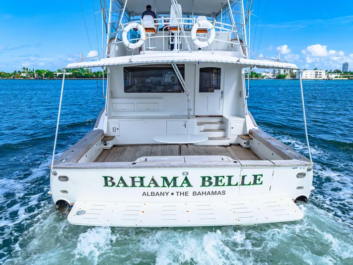 Bahama Belle Yacht Photos Pics Back view of 1996 Blackwell 72 yacht Bahama Belle cruising in clear blue waters.