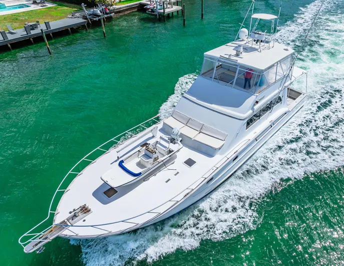 Bahama Belle Yacht Photos Pics Aerial view of a 1996 Blackwell 72 yacht cruising in clear green waters.