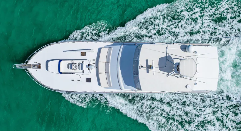 Bahama Belle Yacht Photos Pics Aerial view of a 1996 Blackwell 72 yacht cruising on turquoise waters.