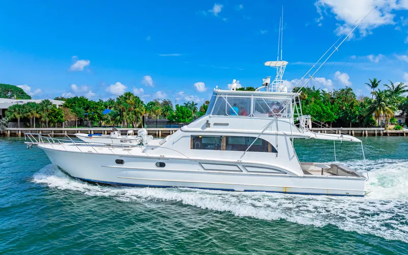 Bahama Belle Yacht Photos Pics 1996 Blackwell 72 yacht cruising on a sunny day near a tropical shoreline.