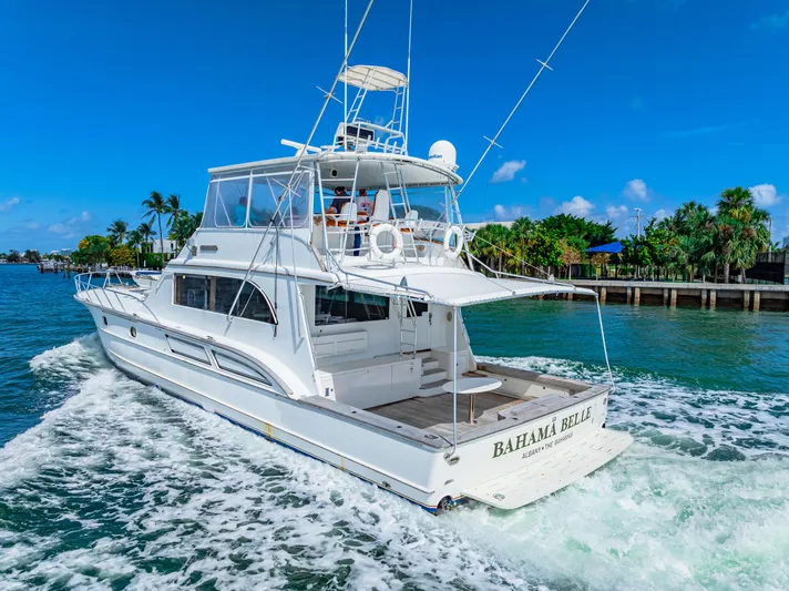 Bahama Belle Yacht Photos Pics White 1996 Blackwell 72 yacht cruising in tropical waters near a lush coastline.