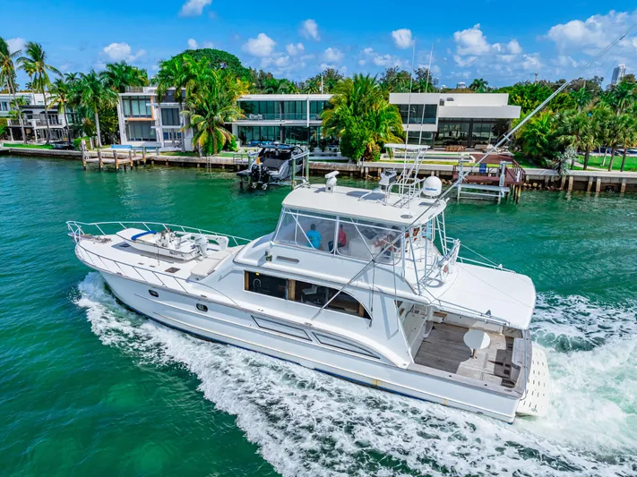 Bahama Belle Yacht Photos Pics White 1996 Blackwell 72 yacht cruising near waterfront homes on a sunny day.