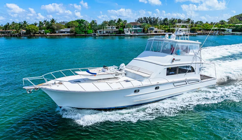 Bahama Belle Yacht Photos Pics 1996 Blackwell 72 yacht cruising on a sunny day near a tropical shoreline.