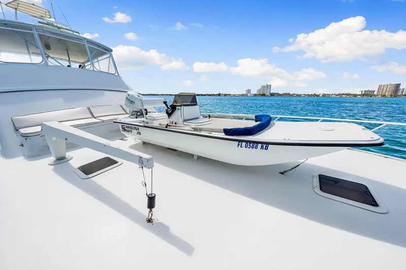 Bahama Belle Yacht Photos Pics Blackwell 72 yacht (1996) with a small boat on deck, docked by the ocean.