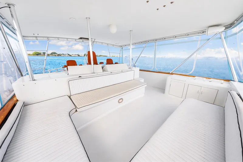 Bahama Belle Yacht Photos Pics Spacious interior of a 1996 Blackwell 72 yacht with white seating and ocean view.