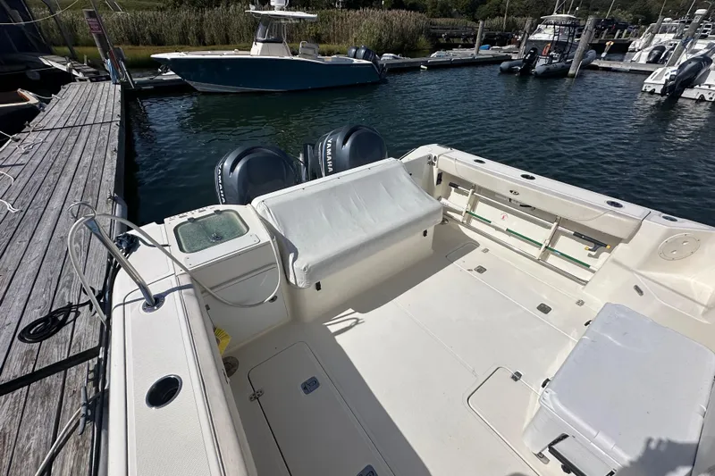  Yacht Photos Pics 2010 Pursuit OS 315 Offshore boat docked, featuring spacious deck and twin Yamaha engines.