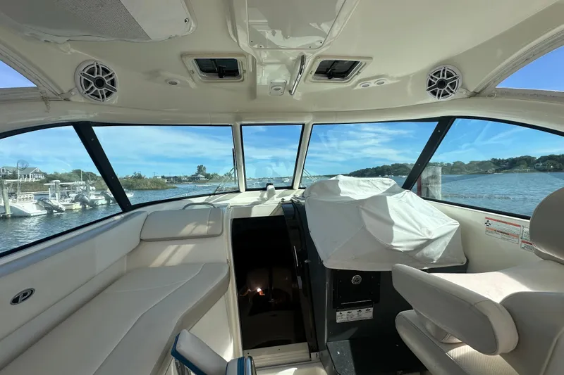  Yacht Photos Pics Interior view of 2010 Pursuit OS 315 Offshore boat with scenic water backdrop.