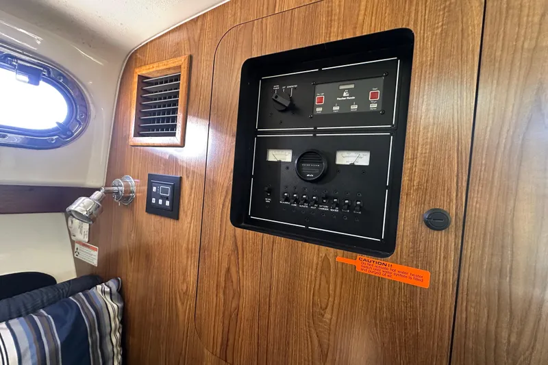  Yacht Photos Pics Control panel inside 2010 Pursuit OS 315 Offshore boat, featuring wood paneling and gauges.