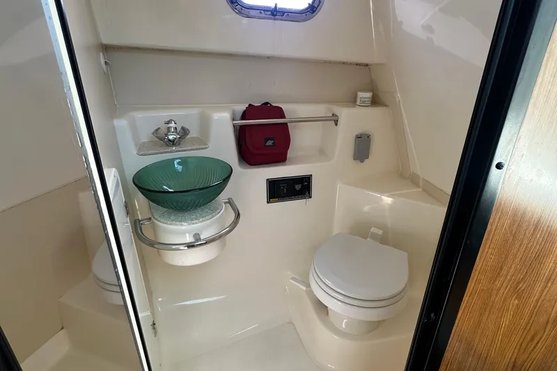  Yacht Photos Pics 2010 Pursuit OS 315 Offshore boat bathroom with modern fixtures and glass sink.