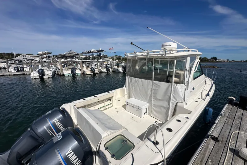  Yacht Photos Pics 2010 Pursuit OS 315 Offshore boat docked with Yamaha engines, marina background.