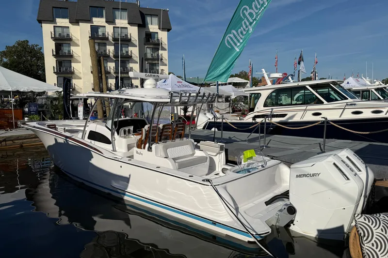  Yacht Photos Pics 2026 Mag Bay 38 CC boat docked at marina, featuring Mercury engines.