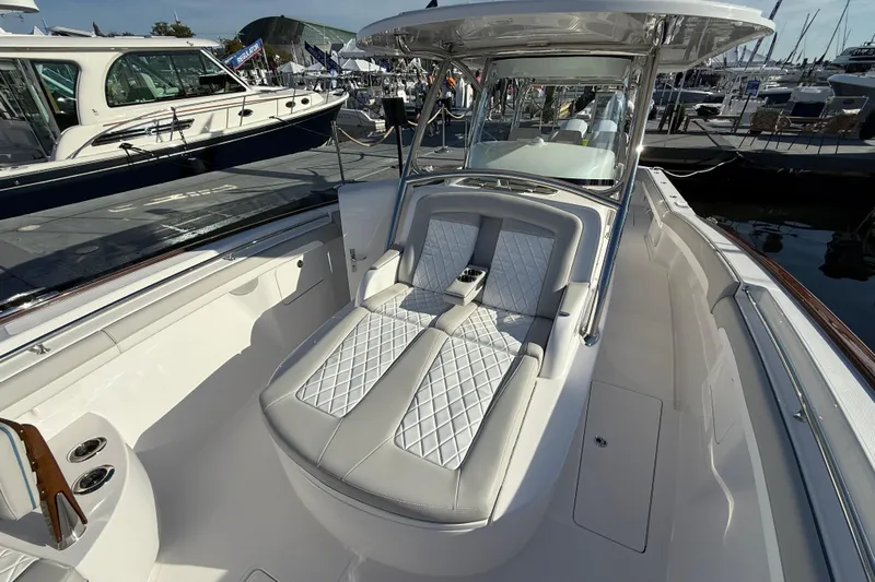  Yacht Photos Pics 2026 Mag Bay 38 CC boat interior with luxurious seating and sleek design at a marina.