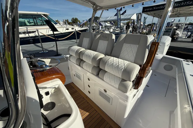  Yacht Photos Pics 2026 Mag Bay 38 CC boat interior with luxurious seating and wooden accents at a yacht show.