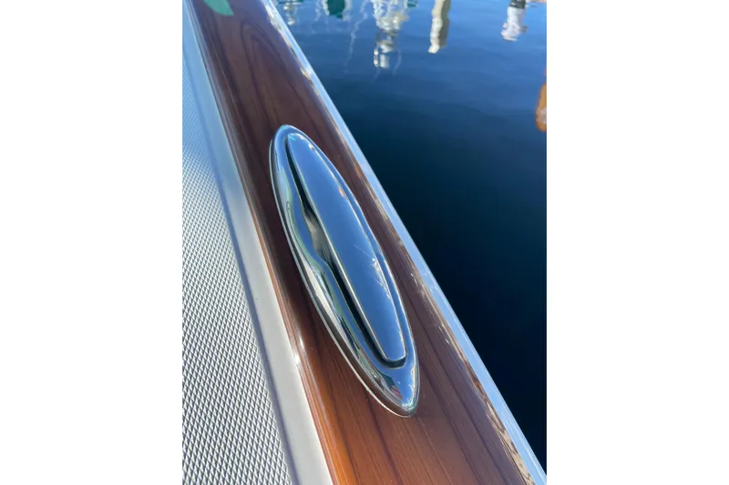  Yacht Photos Pics Sleek cleat on 2026 Mag Bay 38 CC boat, reflecting sunlight on polished wood.