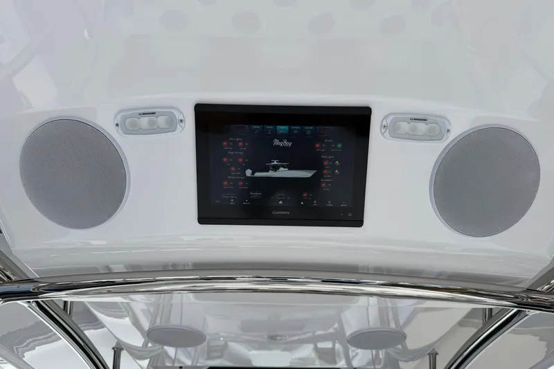  Yacht Photos Pics 2026 Mag Bay 38 CC boat dashboard with Garmin display and speakers.
