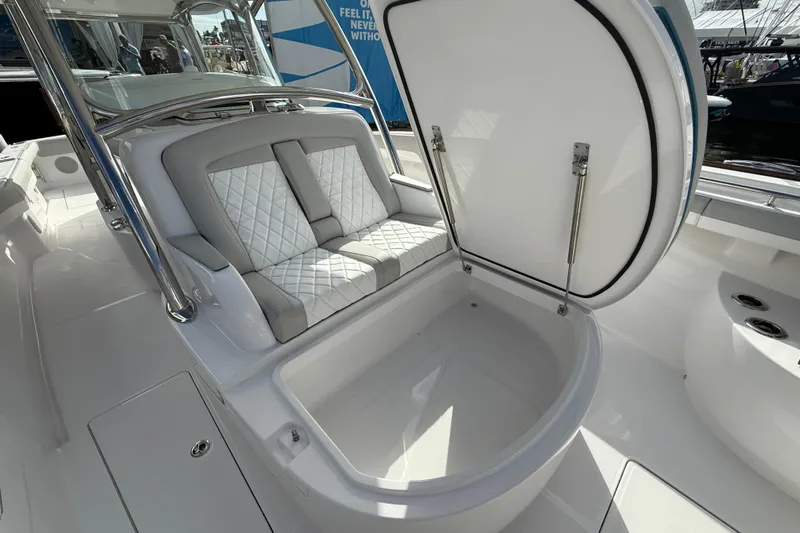  Yacht Photos Pics 2026 Mag Bay 38 CC boat interior with open storage compartment and cushioned seating.