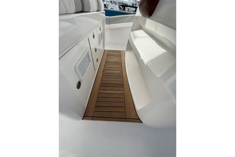  Yacht Photos Pics 2026 Mag Bay 38 CC boat interior with teak flooring and white cabinetry.
