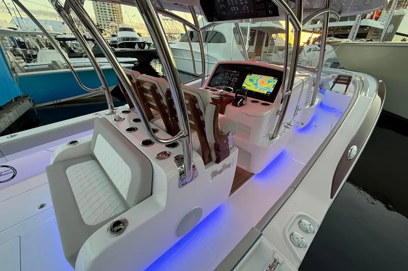  Yacht Photos Pics 2026 Mag Bay 38 CC boat interior with illuminated console and seating at marina.