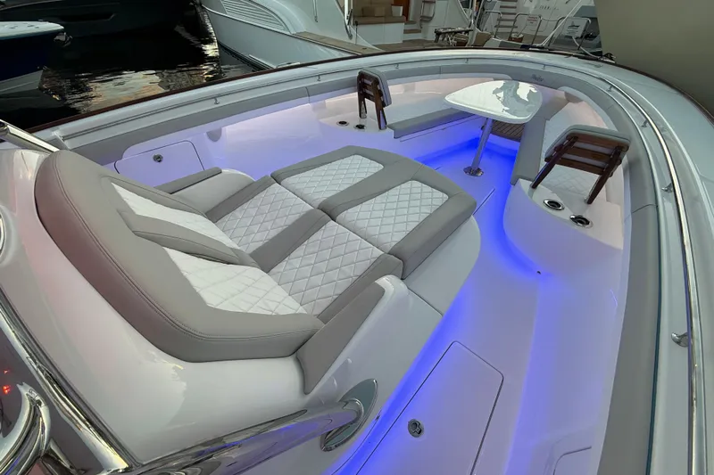  Yacht Photos Pics Luxurious 2026 Mag Bay 38 CC boat interior with elegant seating and ambient blue lighting.