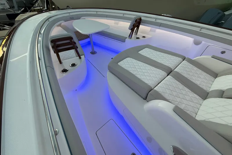  Yacht Photos Pics Luxurious 2026 Mag Bay 38 CC boat interior with elegant seating and ambient blue lighting.