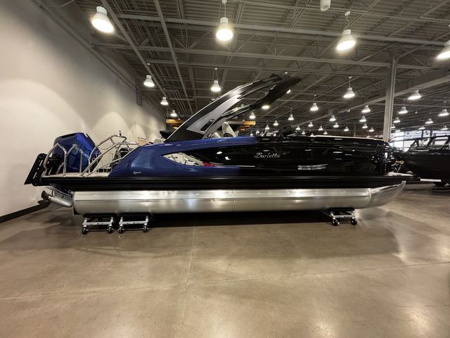 2025 Barletta Boats R23UCA pontoon in showroom, featuring sleek design and modern lighting.