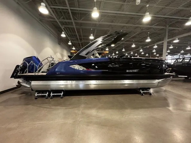 2025 Barletta Boats R23UCA pontoon in showroom, featuring sleek design and modern lighting.