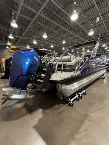 2025 Barletta Boats R23UCA pontoon with blue motor in showroom.